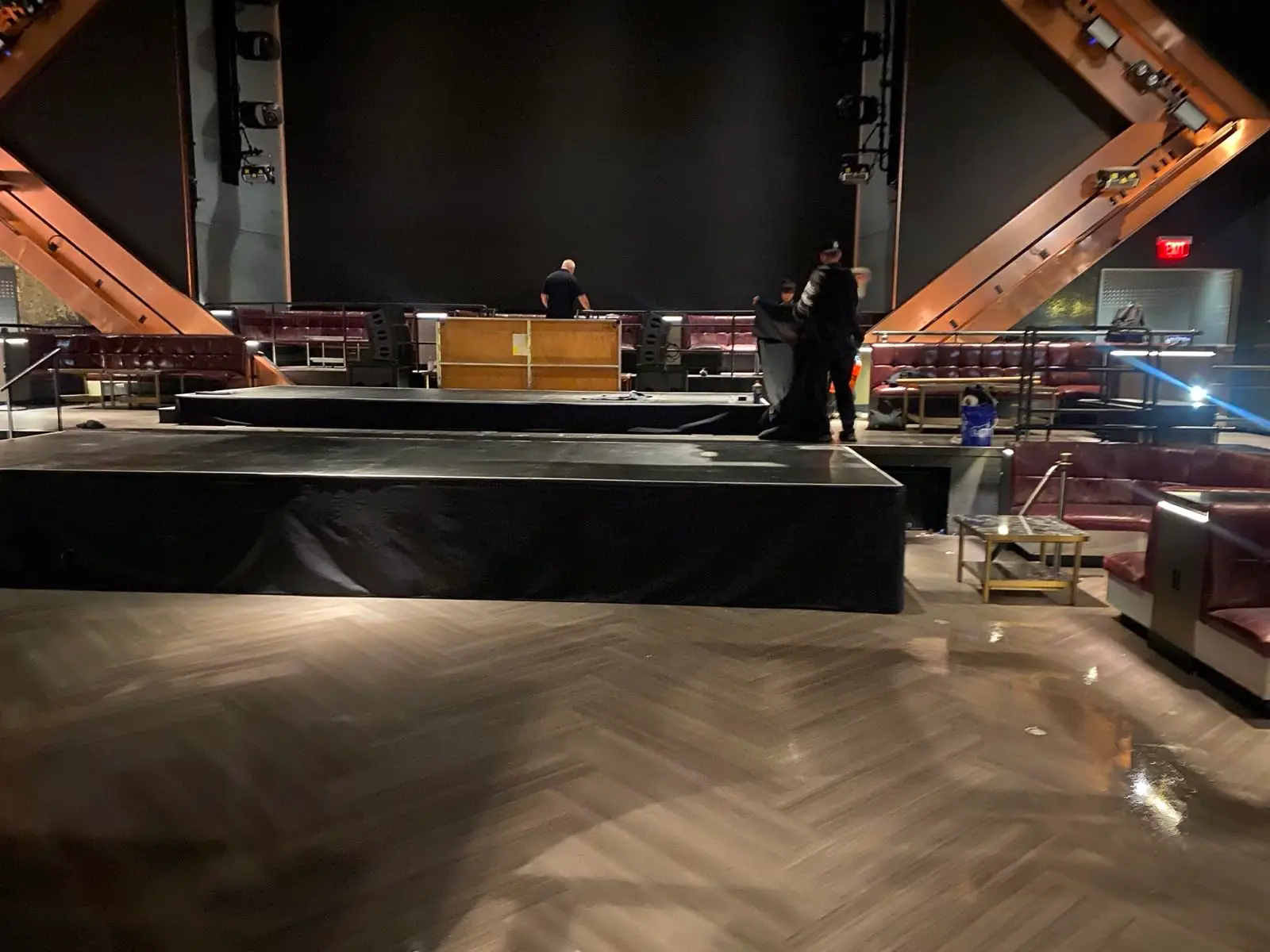 Crew building multi-level stage at venue