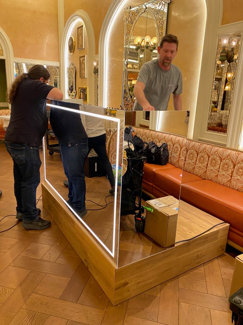 Crew members installing LED display panel at event venue